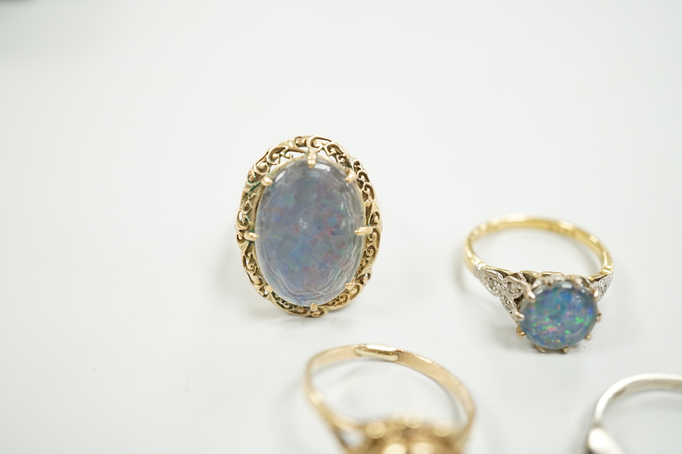 A 1940's 18ct and black opal doublet set dress ring, with diamond chip set shoulders, size L, a 14c and oval doublet ring and two other 9ct and gem set rings.